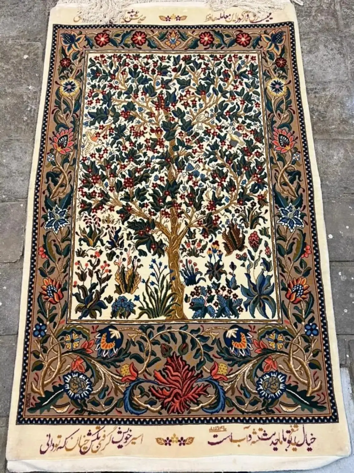 Full view of Tree of Life handmade Kashan rug with ivory field, birds, blossoms and botanical border