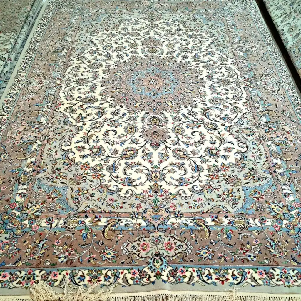 Full view of Sacred Lachak Toranj handmade Kashan carpet with ivory field, floral medallion and taupe-blue border