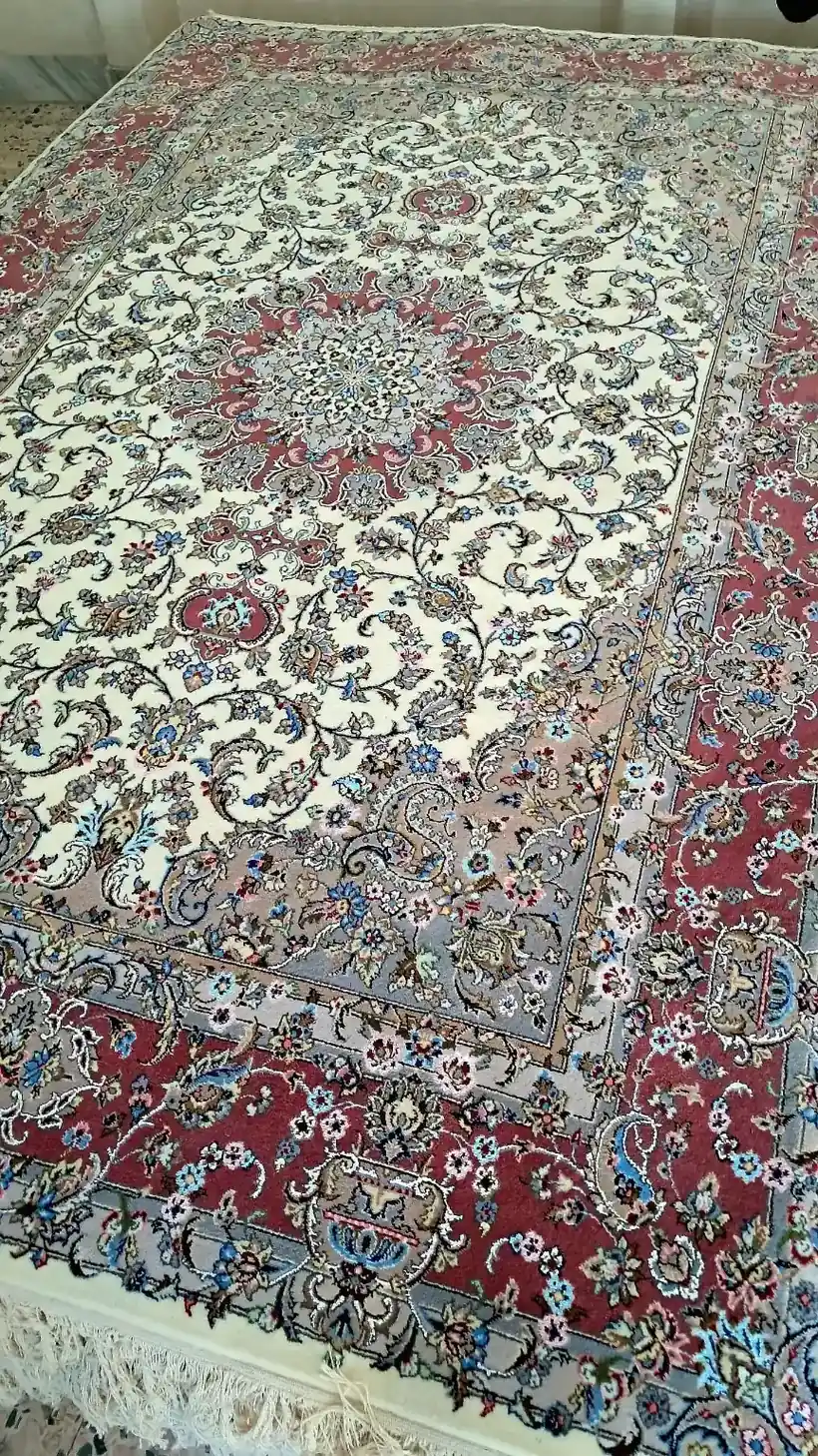 Verified angled view of Sacred Lachak Toranj handmade Kashan carpet with ivory field, rose-red medallion and border