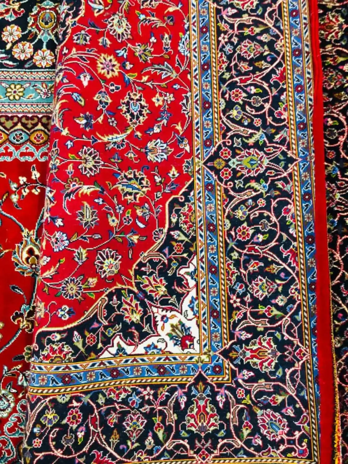 Second verified detail of PRR-KH-036 showing silk floral motifs, ruby field, dark border and blue guard bands