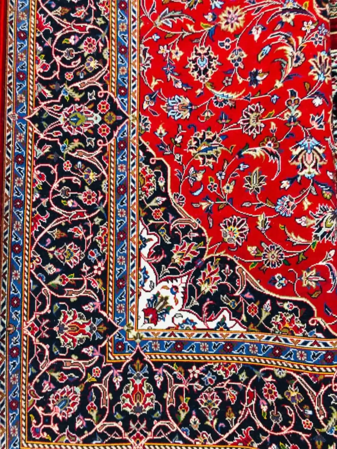 Verified detail view of PRR-KH-036 Imperial Ruby Heritage handmade Kashan carpet with ruby-red field and midnight floral border