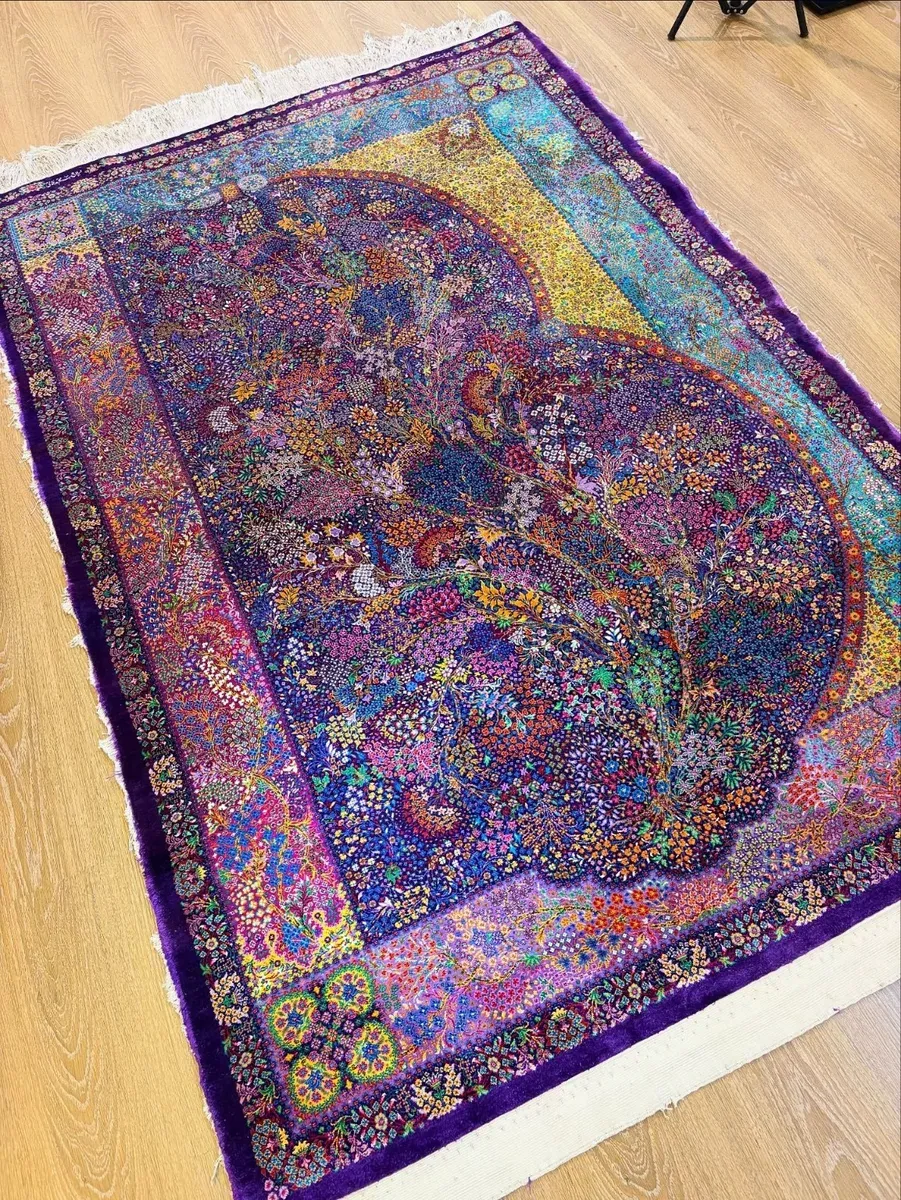 Midnight Paisley Garden handmade Qom pure silk carpet with a monumental Boteh Jegheh filled with flowers and a colourful patchwork border