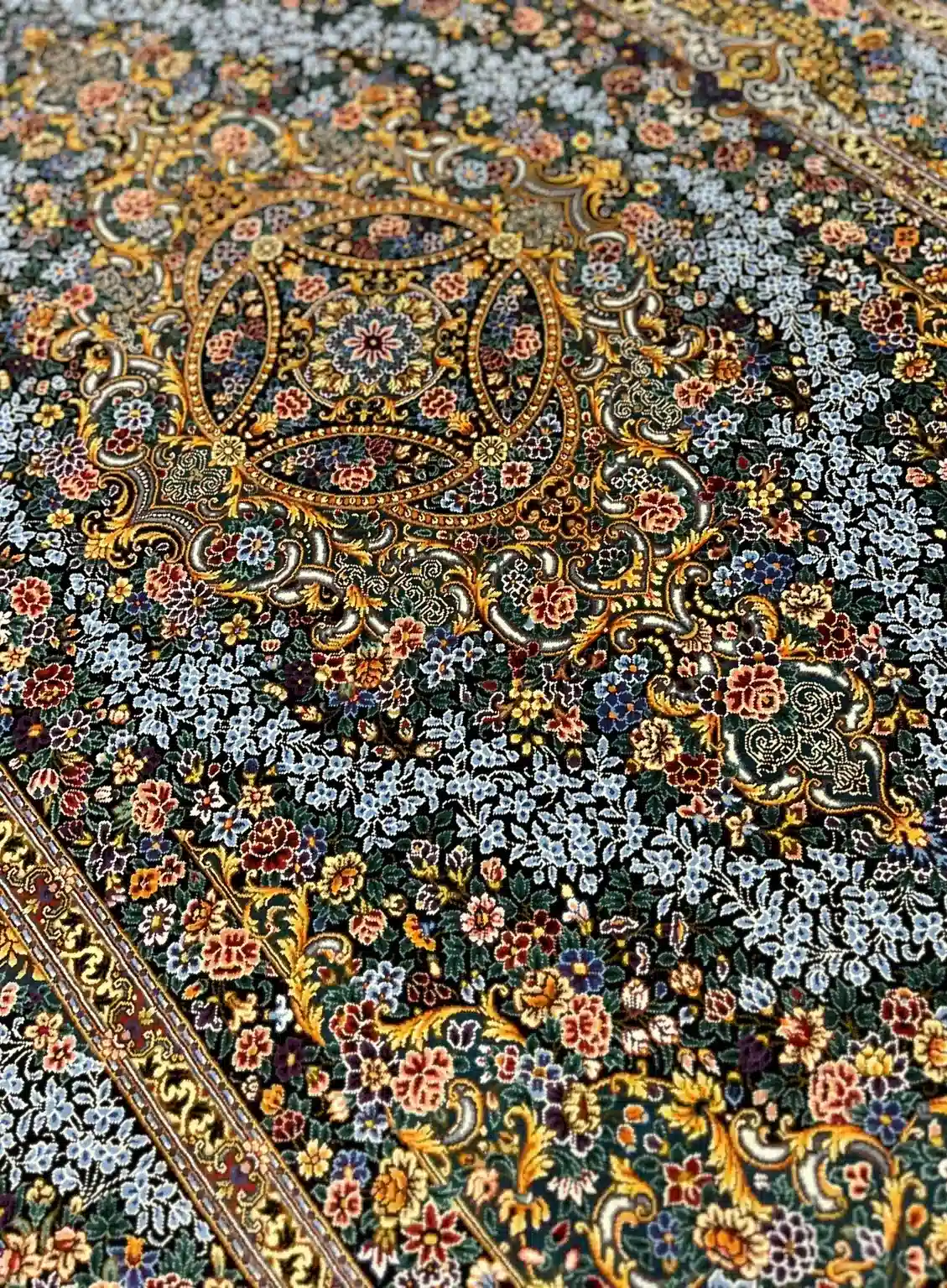 Emerald Jewel Rosette handmade Qom pure silk carpet featuring an intricate jewel-like Toranj surrounded by cool blue blossoms and scrolling Shah Abbasi arabesques