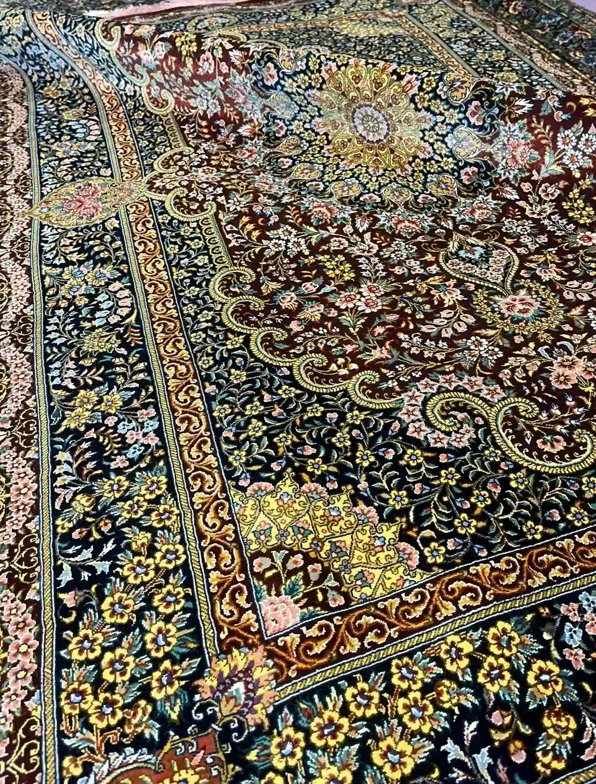 Burgundy Pavilion Grandeur handmade Qom pure silk carpet featuring a grand burgundy field, radiant floral rosette and richly layered Shah Abbasi borders