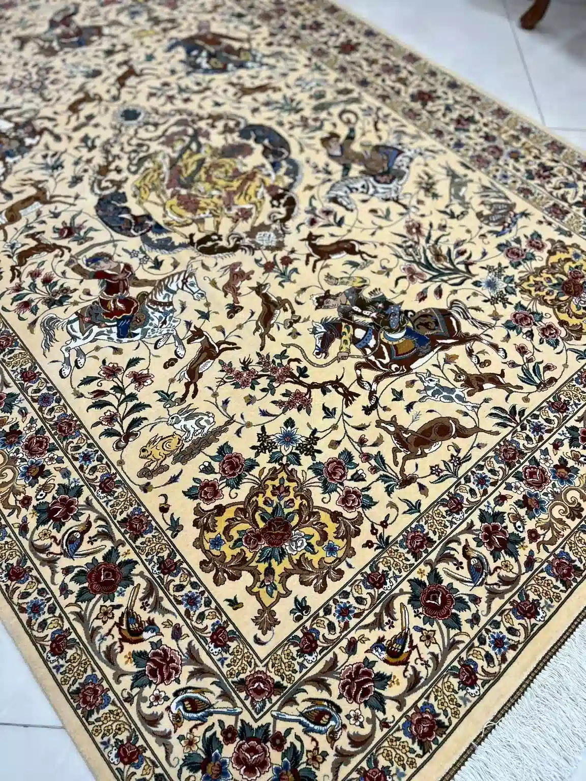 Ivory Courtly Hunt handmade Qom pure silk carpet featuring a refined courtly hunt with horsemen, wild animals and flowering vines unfolding across a luminous ivory field