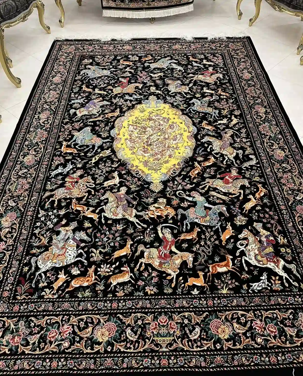 Golden Imperial Hunt handmade Qom pure silk carpet featuring a monumental royal hunting scene centred on a golden medallion, with riders, animals and flowering borders