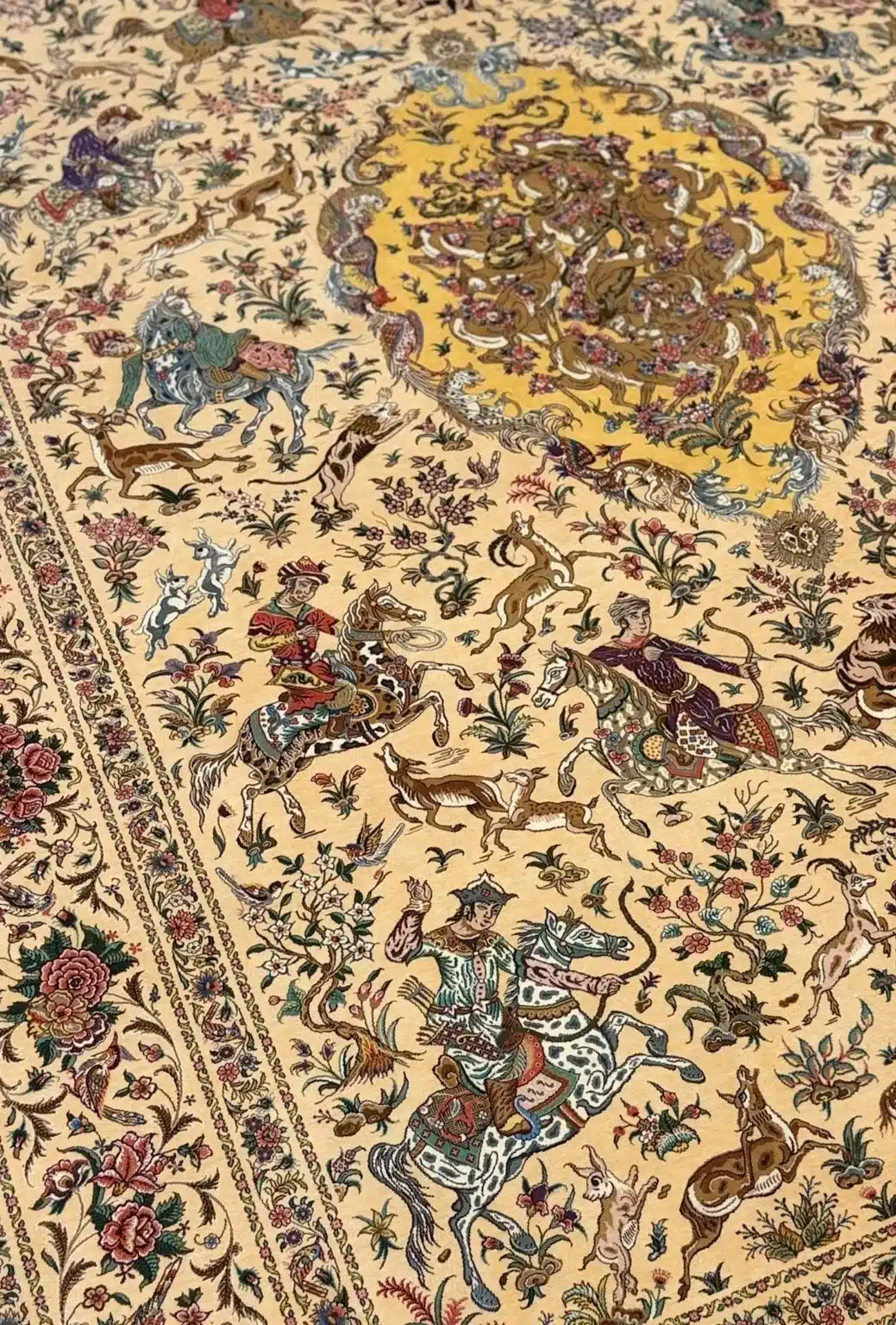 Ivory Imperial Hunt handmade Qom pure silk carpet featuring an expansive royal hunting narrative arranged around a radiant golden medallion