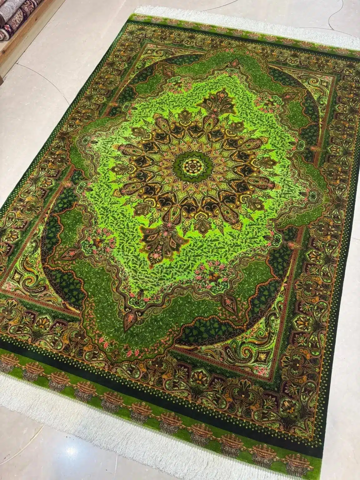 Emerald Imperial Star handmade Qom pure silk carpet featuring a dramatic star medallion set within layered emerald fields and sweeping paisley arabesques